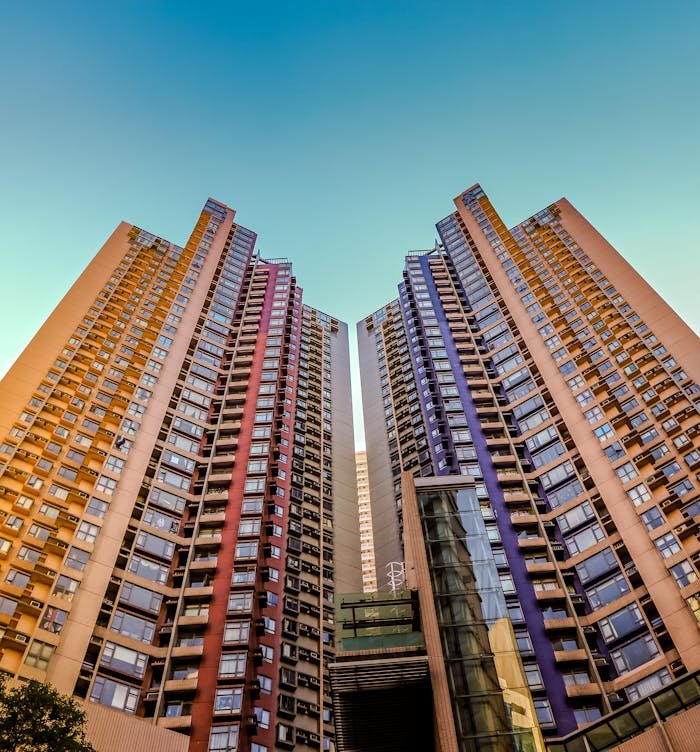 creative Tall, colorful skyscrapers reaching into the blue sky in Hong Kong, showcasing modern architecture.
